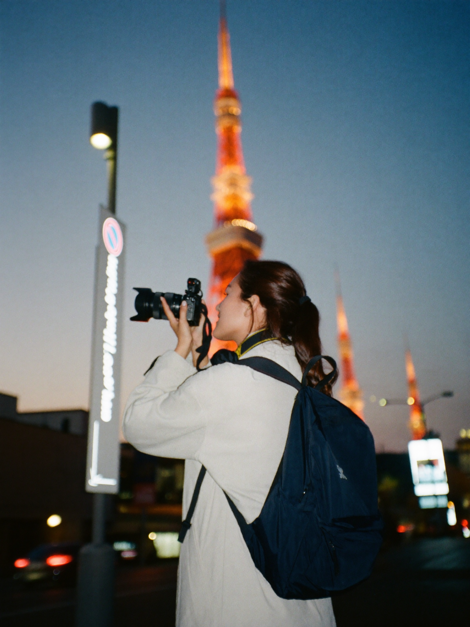 A creator filming street content in Tokyo at dusk